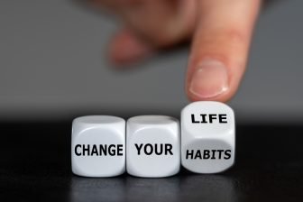 Hand,Turns,Dice,And,Changes,The,Slogan,’change,Your,Habits’ Hand,Turns,Dice,And,Changes,The,Slogan,'change,Your,Habits'